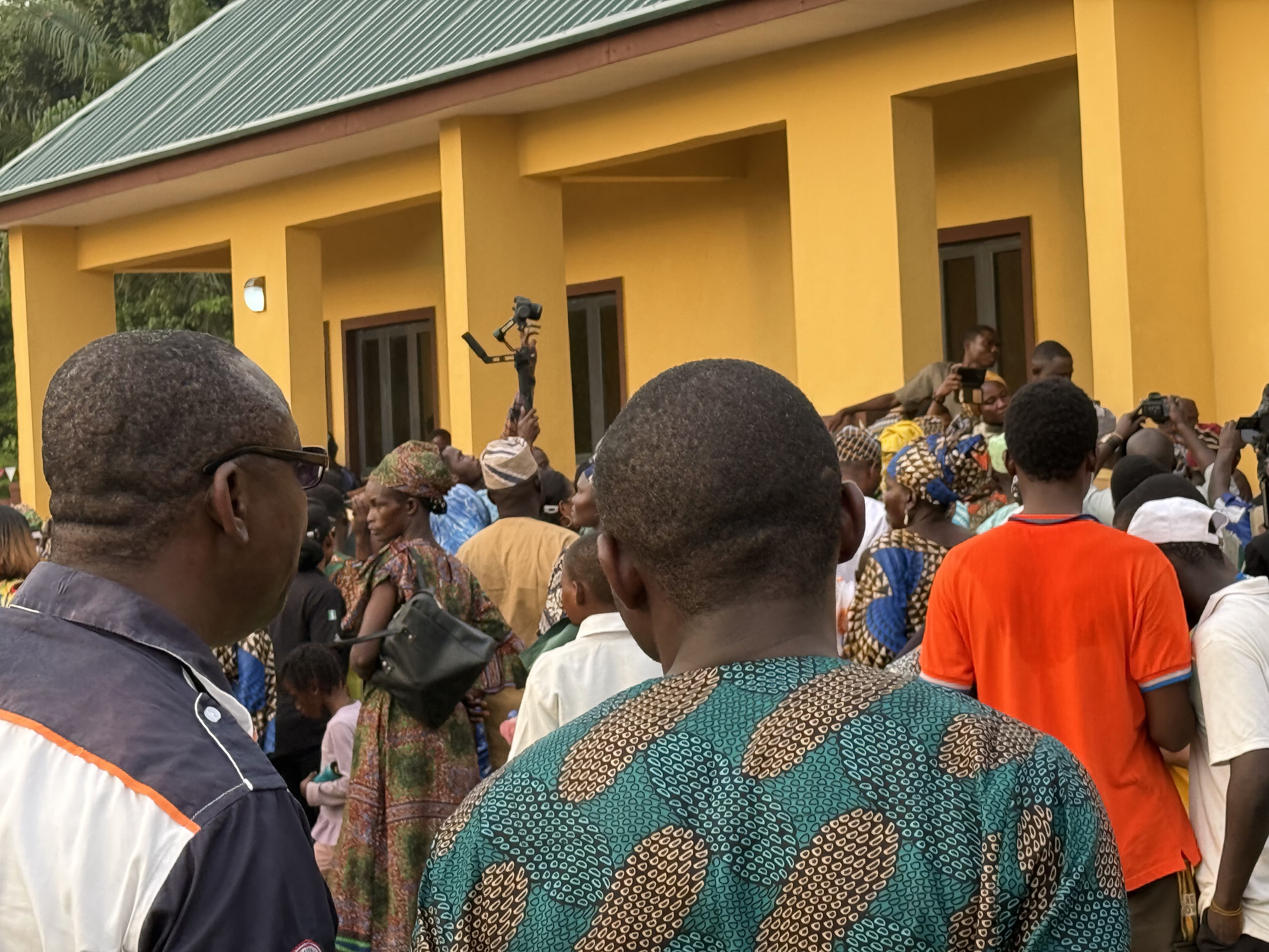 Commissioning ceremony &mdash; press and community members at the hall entrance