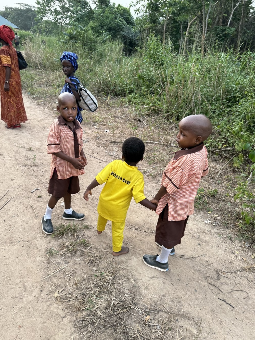 Young children in school uniform walking to school at Onipe, Ibadan